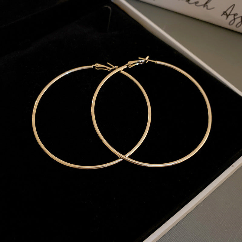 Gold thin hoop earrings in black jewelry box