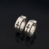 Silver huggie hoop earrings with black cross design, stainless steel hinged closure, gothic style jewelry accessories