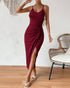 Woman wearing red ribbed knit midi dress with side slit and spaghetti straps.