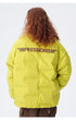Female model showcasing yellow Impressionism puffer jacket with beige pants