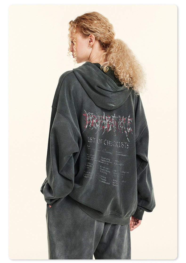 Back view of woman with curly hair in gray hoodie featuring metal-style graphic and text list on back