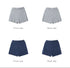 Matching cable knit shorts in grey and navy colorways, shown from front and back. Elastic waistband with all-over cable pattern.