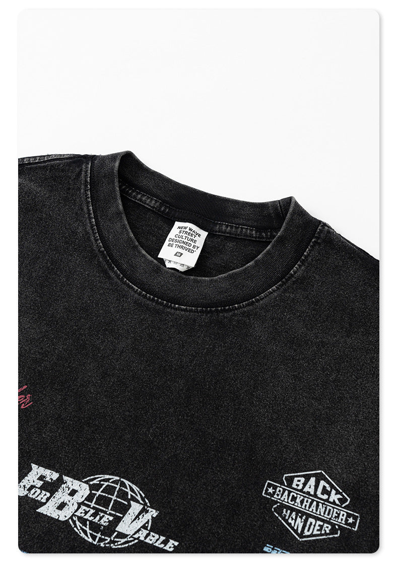 Close-up of black t-shirt neckline showing New Wave Street Culture tag and ribbed collar against white background