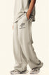 Side view of model in beige Backstairs sweatpants showing relaxed fit and pocket detail
