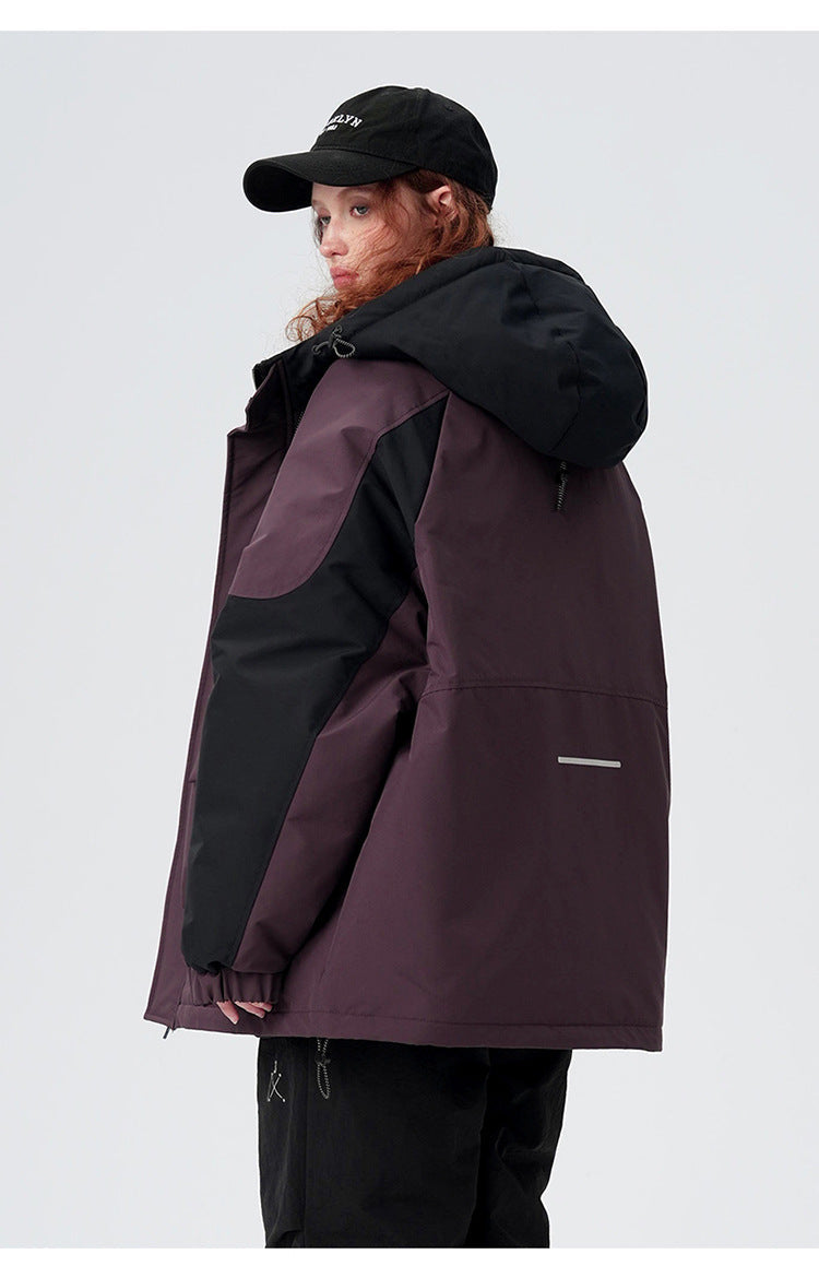 A woman wearing Brooklyn cap shows back view of plum/black All Drifting jacket with hood detail against white background