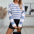 Close-up of blue and white striped sweater with gold necklaces