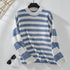 Striped knit sweater on hanger showing ribbed collar and cuffs