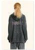 Back view of woman with blonde ponytail in gray hoodie showing metal-style logo and checklist graphic