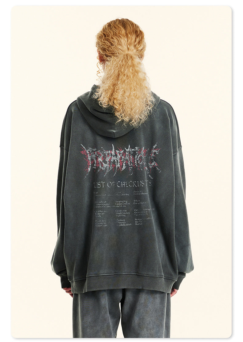 Back view of woman with blonde ponytail in gray hoodie showing metal-style logo and checklist graphic