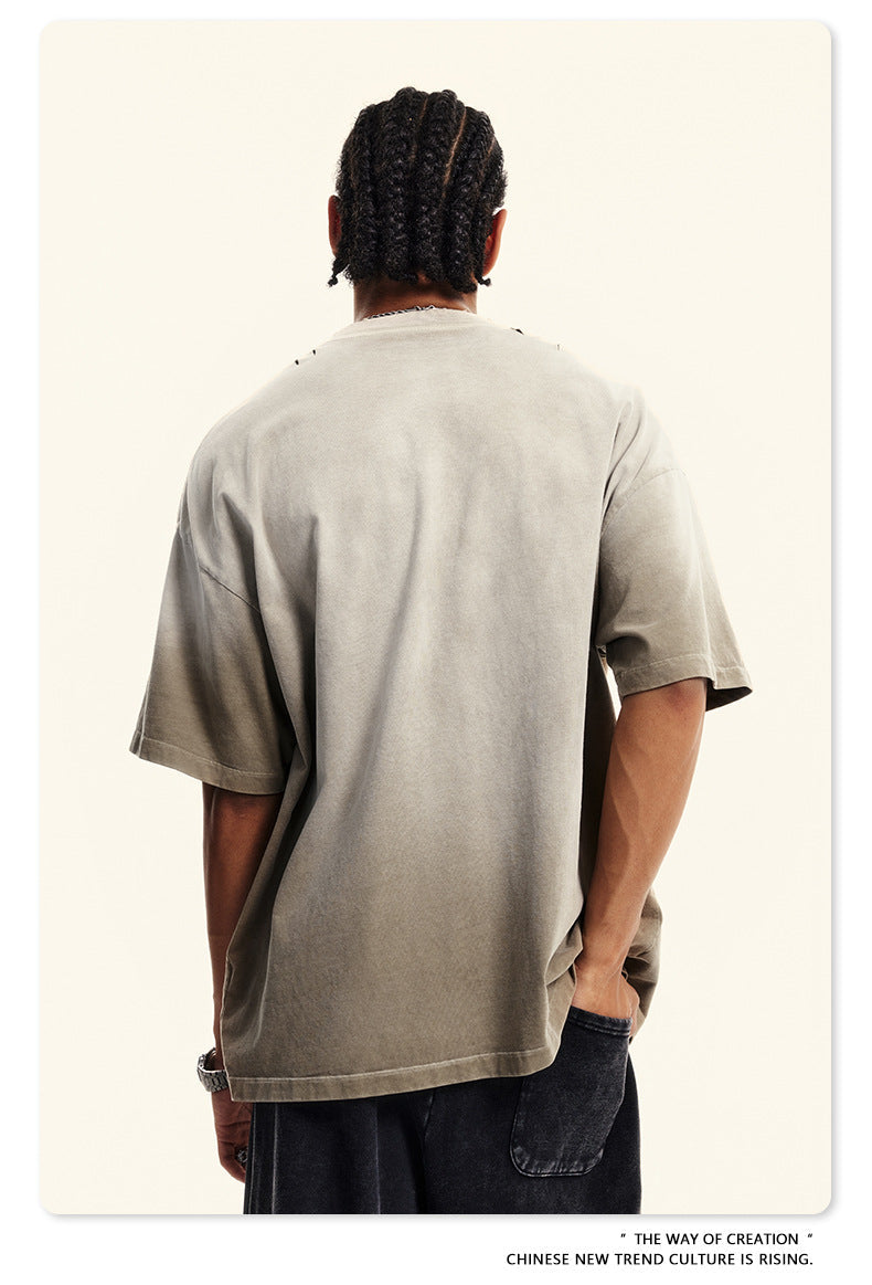 Back view of beige Breaking Tradition tee showing oversized fit and premium cotton construction