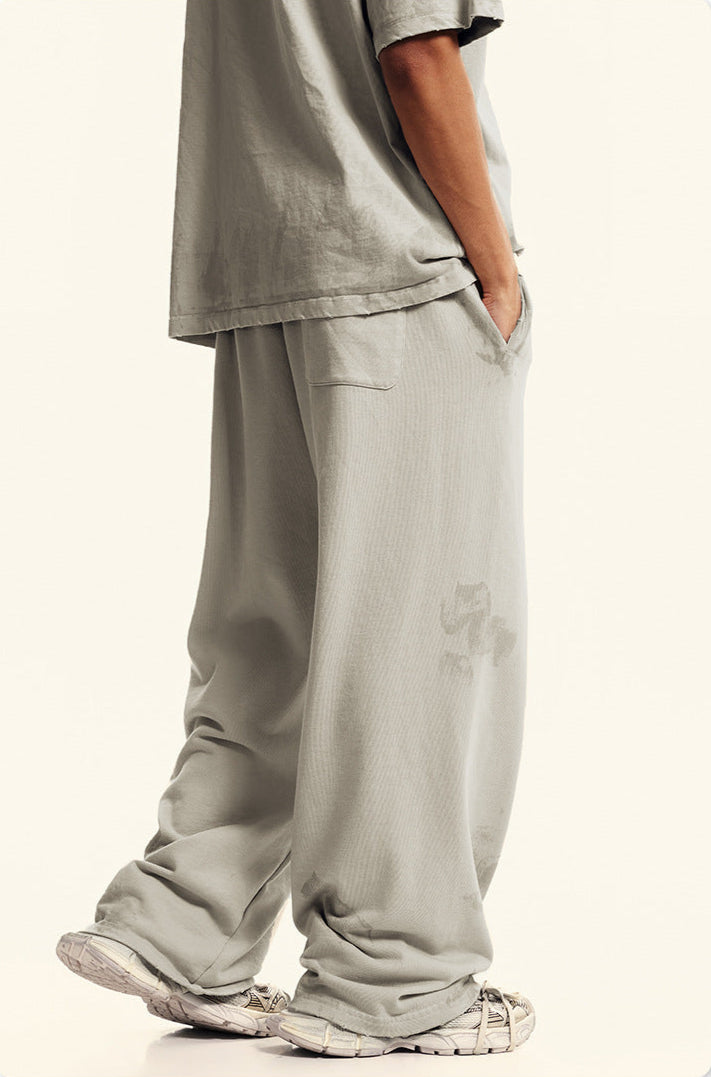 Profile view of beige sweatpants showing loose fit and textured fabric