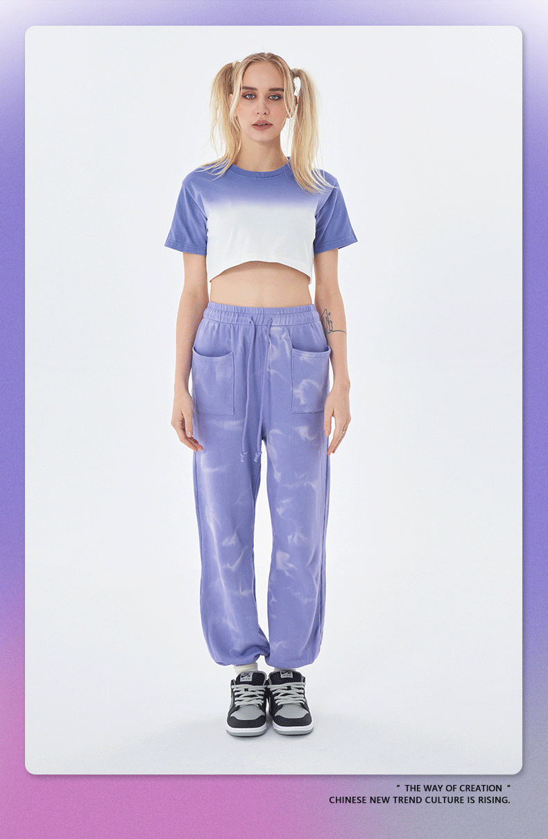Periwinkle tie-dye jogger pants with white and purple ombré cropped t-shirt, gray sneakers