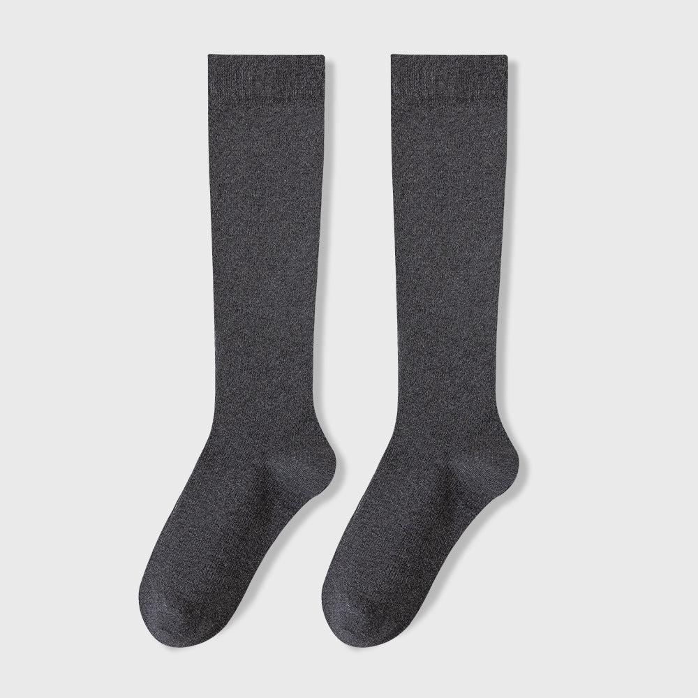 Pair of dark gray knee-high socks displayed against white background showing ribbed texture