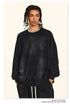 Close-up of black oversized sweatshirt with silver chain necklace, showing dropped shoulder design