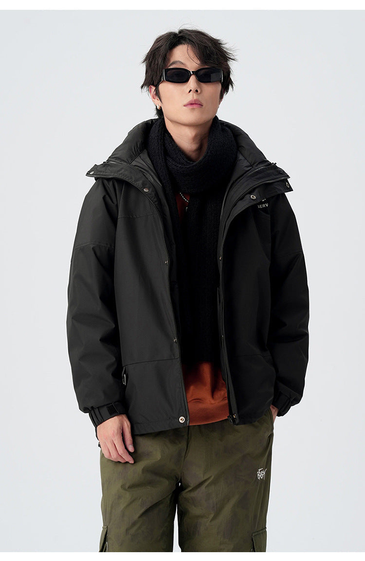 Black hooded jacket styled with brown sweater and olive cargo pants, showing urban streetwear combination