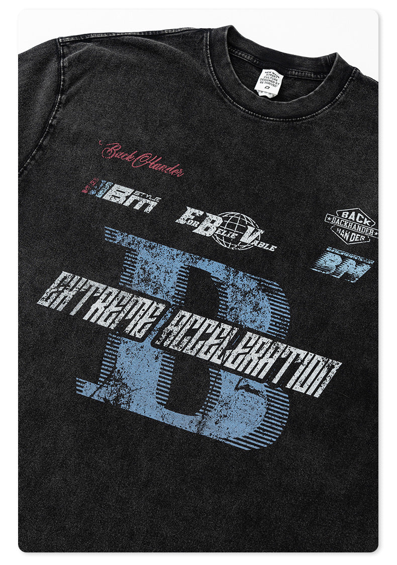 Close-up of black washed t-shirt showing red Backhander script logo and blue B graphic print on front chest area