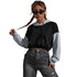 Black-gray hoodie, dark sunglasses, braided hair, vintage jeans, concrete wall pose