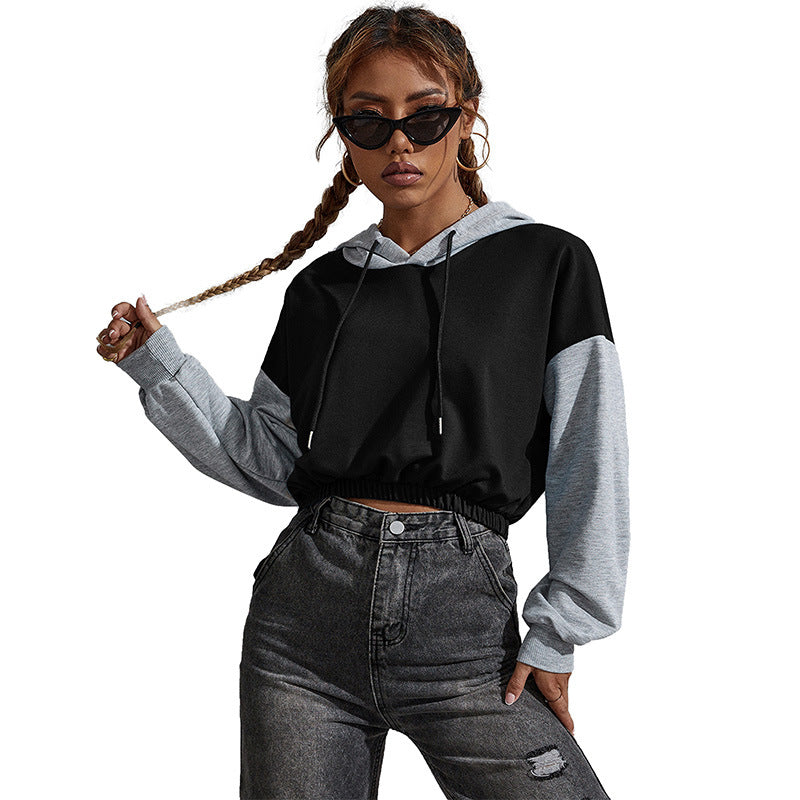 Black-gray hoodie, dark sunglasses, braided hair, vintage jeans, concrete wall pose