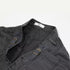Detail shot of waistband showing adjustable side straps, metal hardware, and ITKN brand tag in charcoal fabric