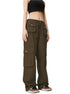 A model is wearing dark olive green cargo pants with multiple flap pockets and a black crop top, standing against a white background