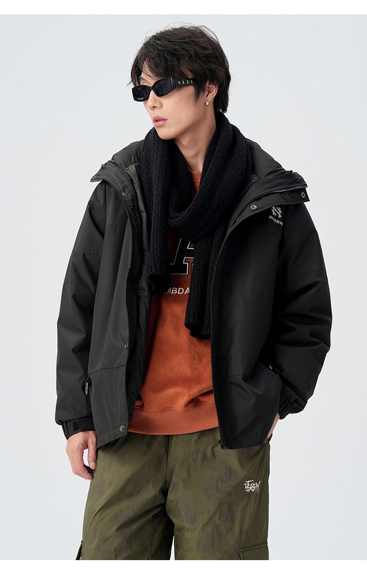 Close-up portrait showcasing black technical jacket with winter accessories and contemporary styling