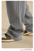 Close-up of grey sweatpants leg showing textured side panel detailing