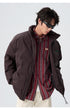 Male model demonstrating brown and black puffer jackets with various styling
