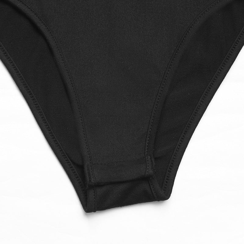 Detail of black bodysuit bottom with snap closure.