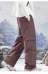 Brown cargo pants demonstrating fit and technical details, photographed against mountain landscape