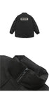 Black winter jacket detail showing BRAVE back patch and zipper closure, material close-up