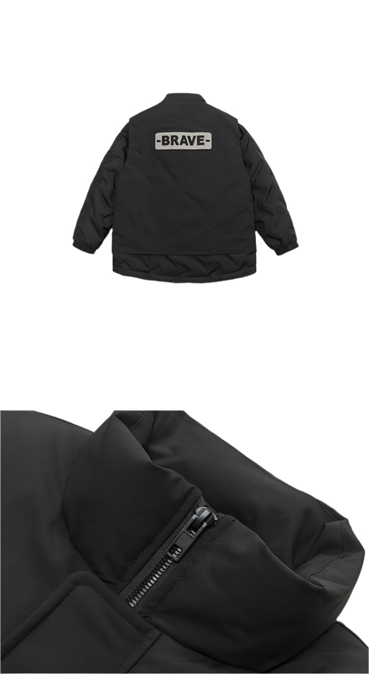 Black winter jacket detail showing BRAVE back patch and zipper closure, material close-up