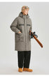 A man in beige beanie with ski goggles models olive green NEIGHBORHOOD parka with logo text across chest against white background