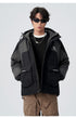 A man in black sunglasses and silver chain necklace models black/gray All Drifting jacket with tan cargo pants against white background