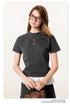 Close-up of dark grey t-shirt with white ruffle hem detail, showing shirt fit and texture
