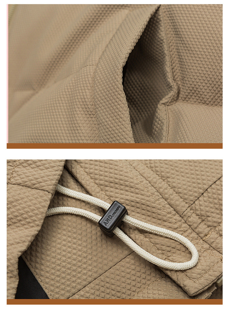 Close-up of tan textured fabric showing pocket detail and drawstring with plastic stopper for adjustable fit