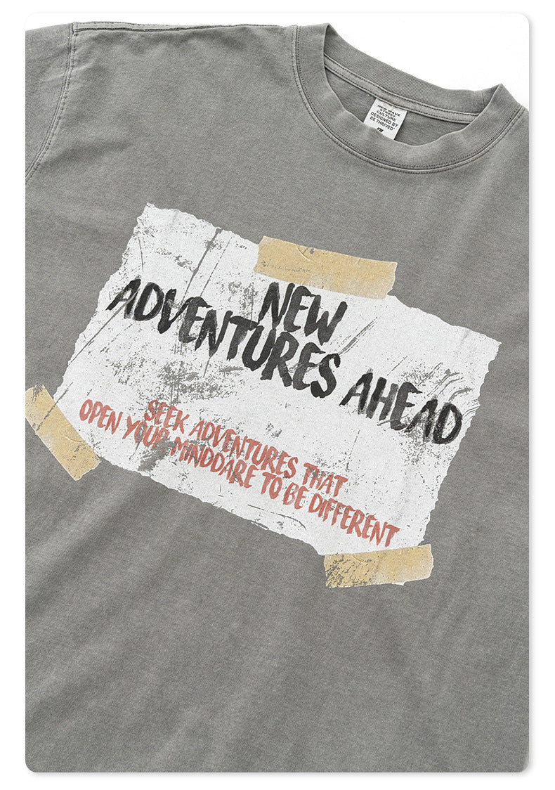 Close-up of gray t-shirt fabric texture showing vintage-style printed graphic design
