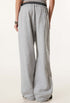 Rear view of grey sweatpants, highlighting the relaxed fit, elastic waistband, and back pocket detail.