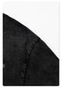 Close-up of black t-shirt sleeve hem stitching detail against white background.