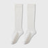 Pair of white knee-high socks displayed flat against light gray background showing full length