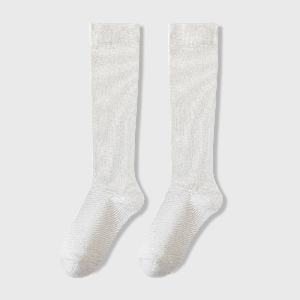 Pair of white knee-high socks displayed flat against light gray background showing full length