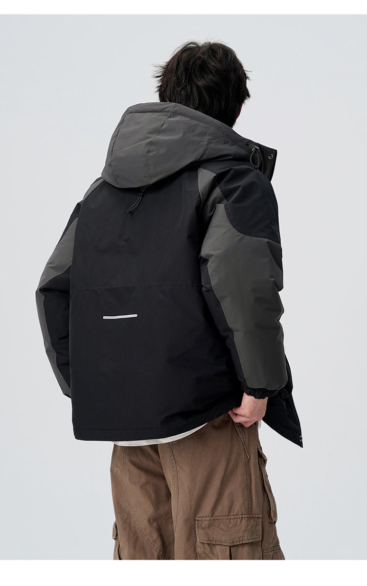 Back view of man showing contrast panels of black and gray All Drifting jacket with reflective detail against white background