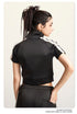 Dark view mock neck crop top with front zip and white sleeve stripes, back view