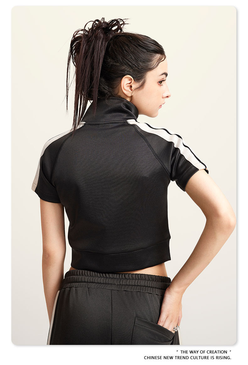 Dark view mock neck crop top with front zip and white sleeve stripes, back view