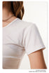 Detail shot of white t-shirt sleeve and side ruching construction