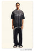 Model in gray Breaking Tradition tee and track pants, showcasing urban streetwear styling