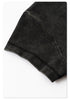 Zoomed-in shot of the neatly stitched hem on the sleeve of the black washed cropped T-shirt