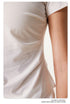 Detail shot of white t-shirt showing side ruching and fabric drape