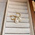 Gold hoop earrings with pearl drops, displayed in jewelry box