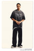 Front view of gray oversized tee with gothic text design, styled with silver accessories