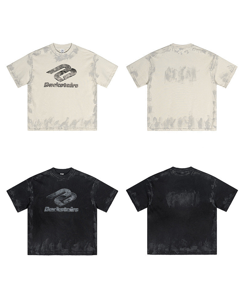 Product lineup showing cream and black Backstairs t-shirts, front and back views with distressed logo print and paint-splatter effect
